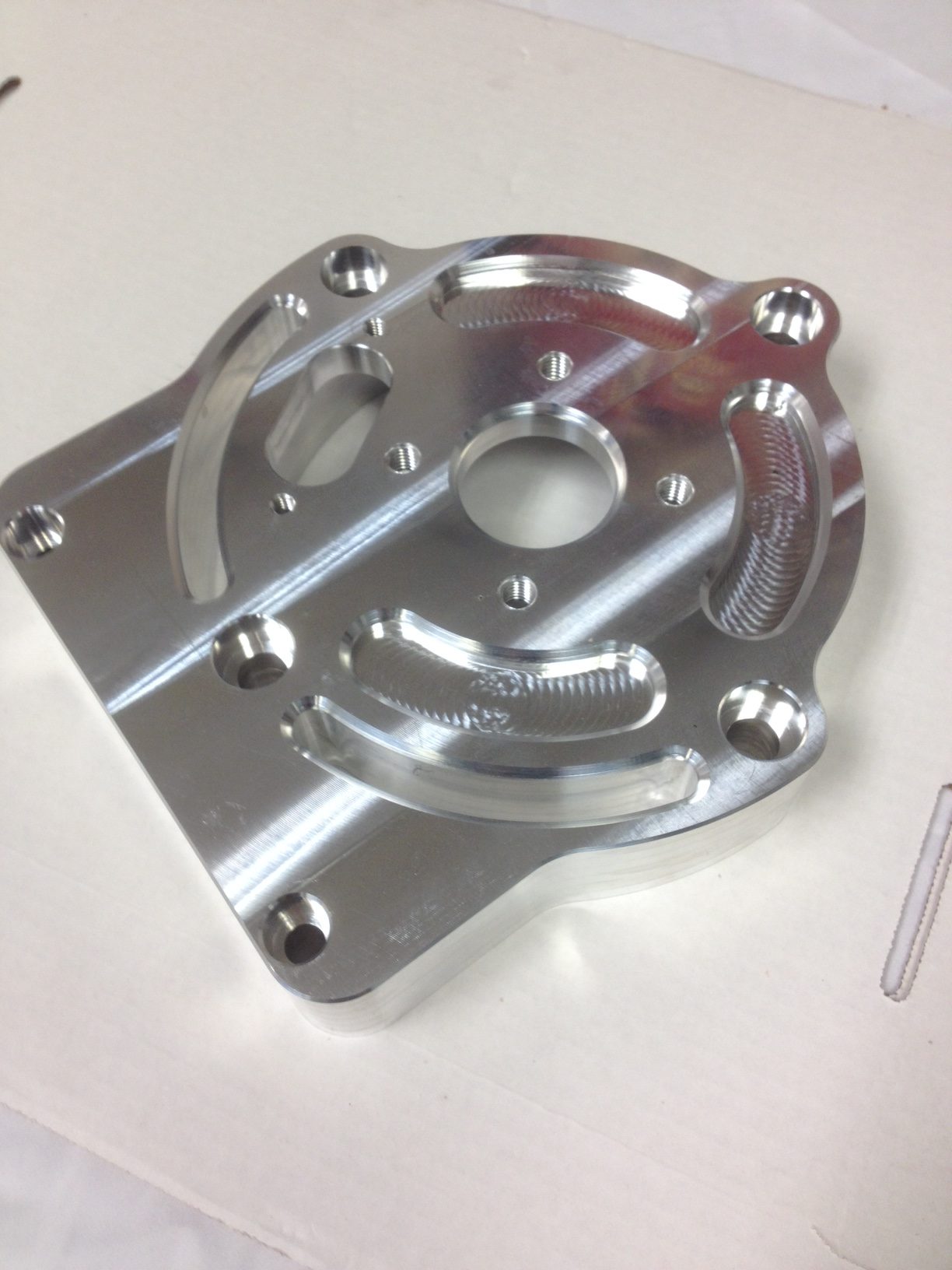 Machined aluminum plate with pockets, bores and curved geometry